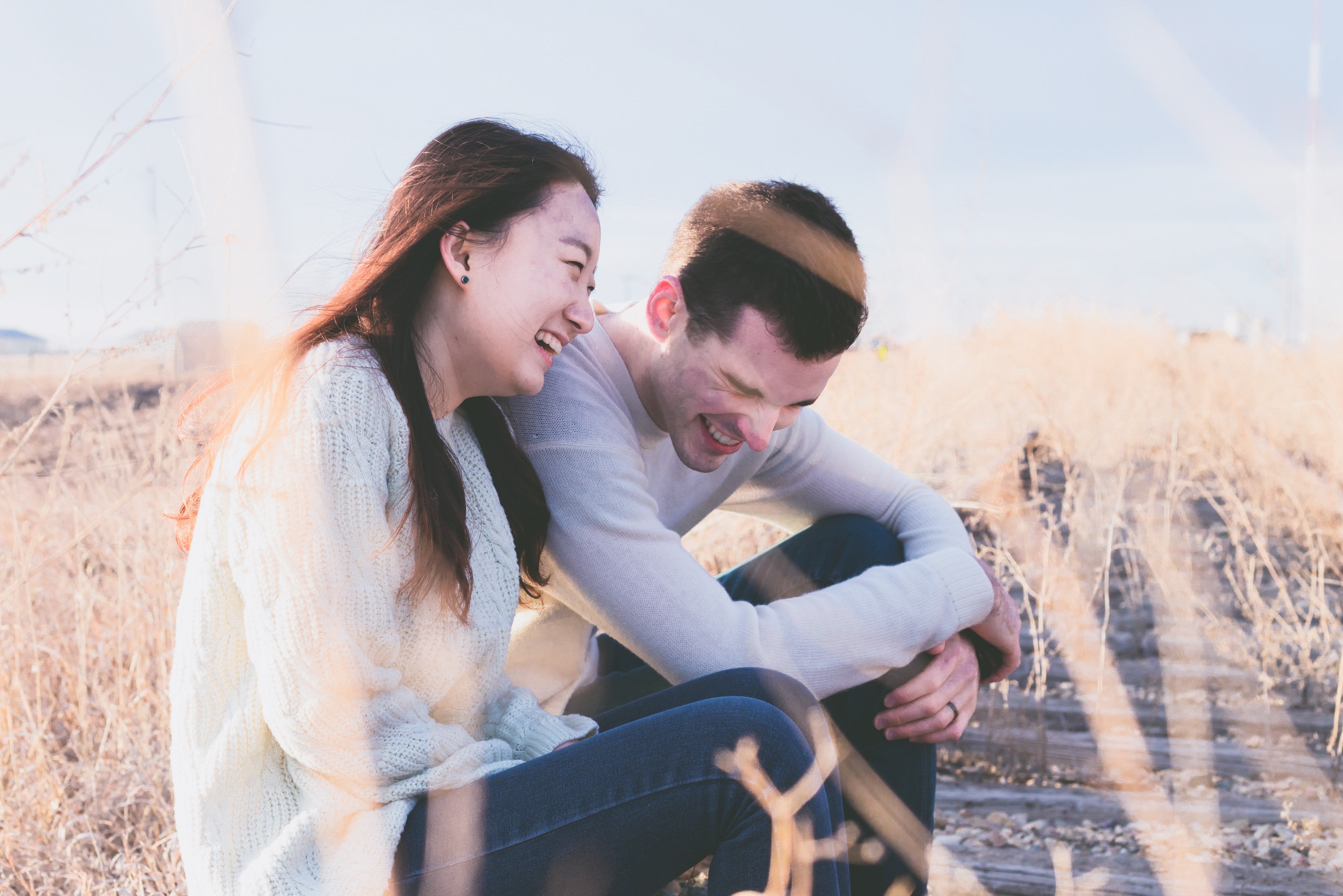 young laughing couple in field