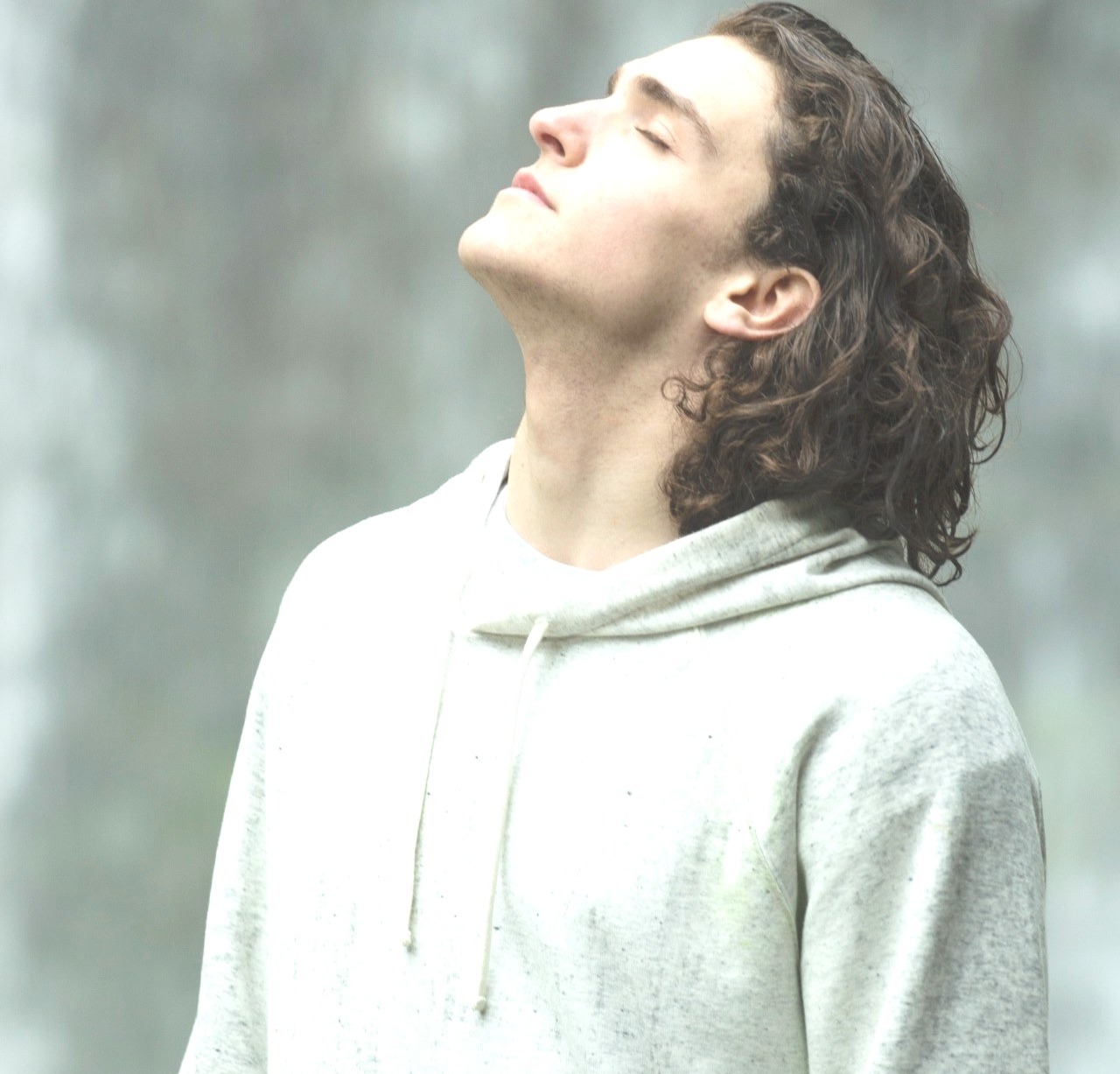 man feeling relief basking in sunlight