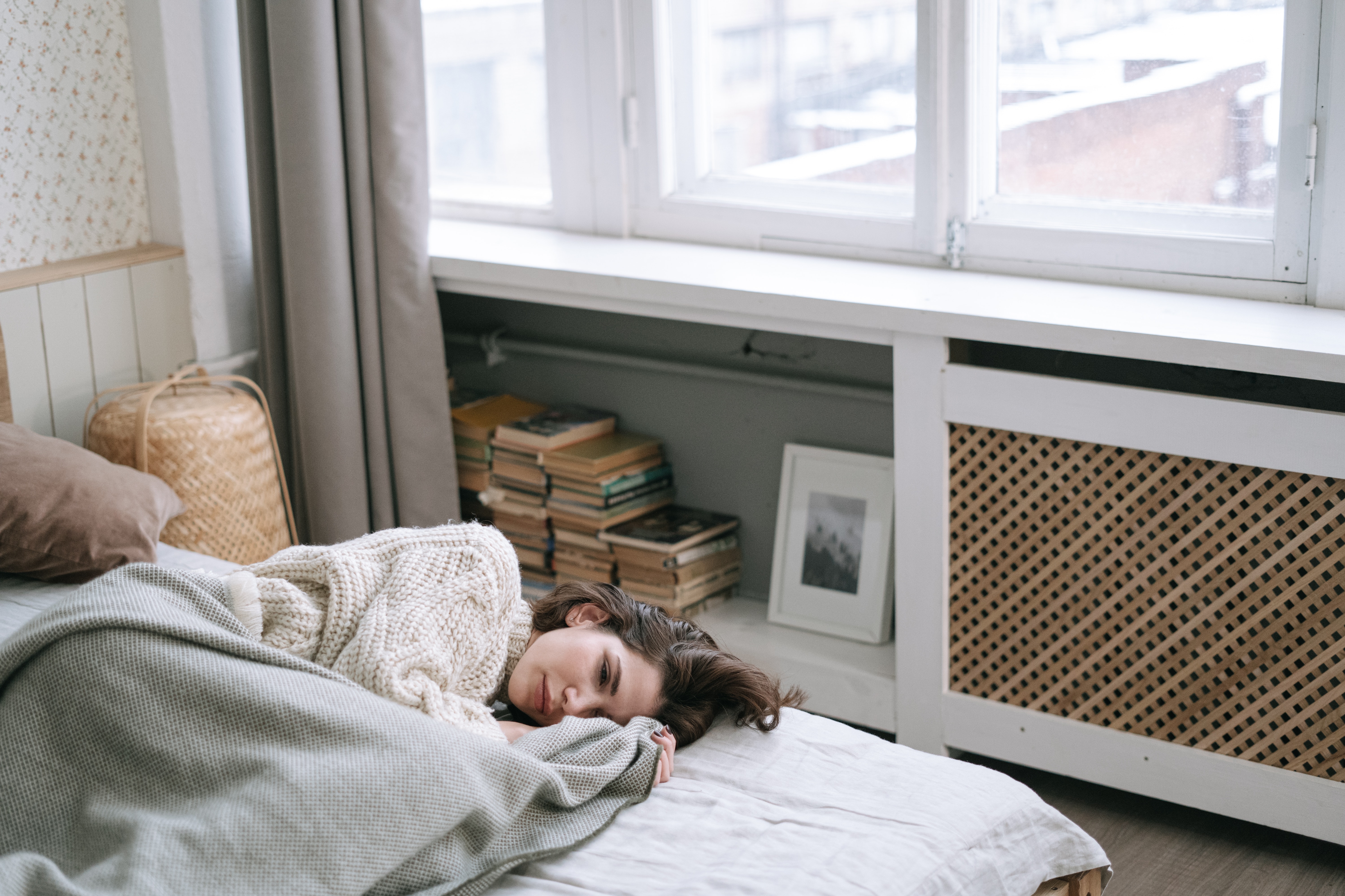 very sad woman on her bed