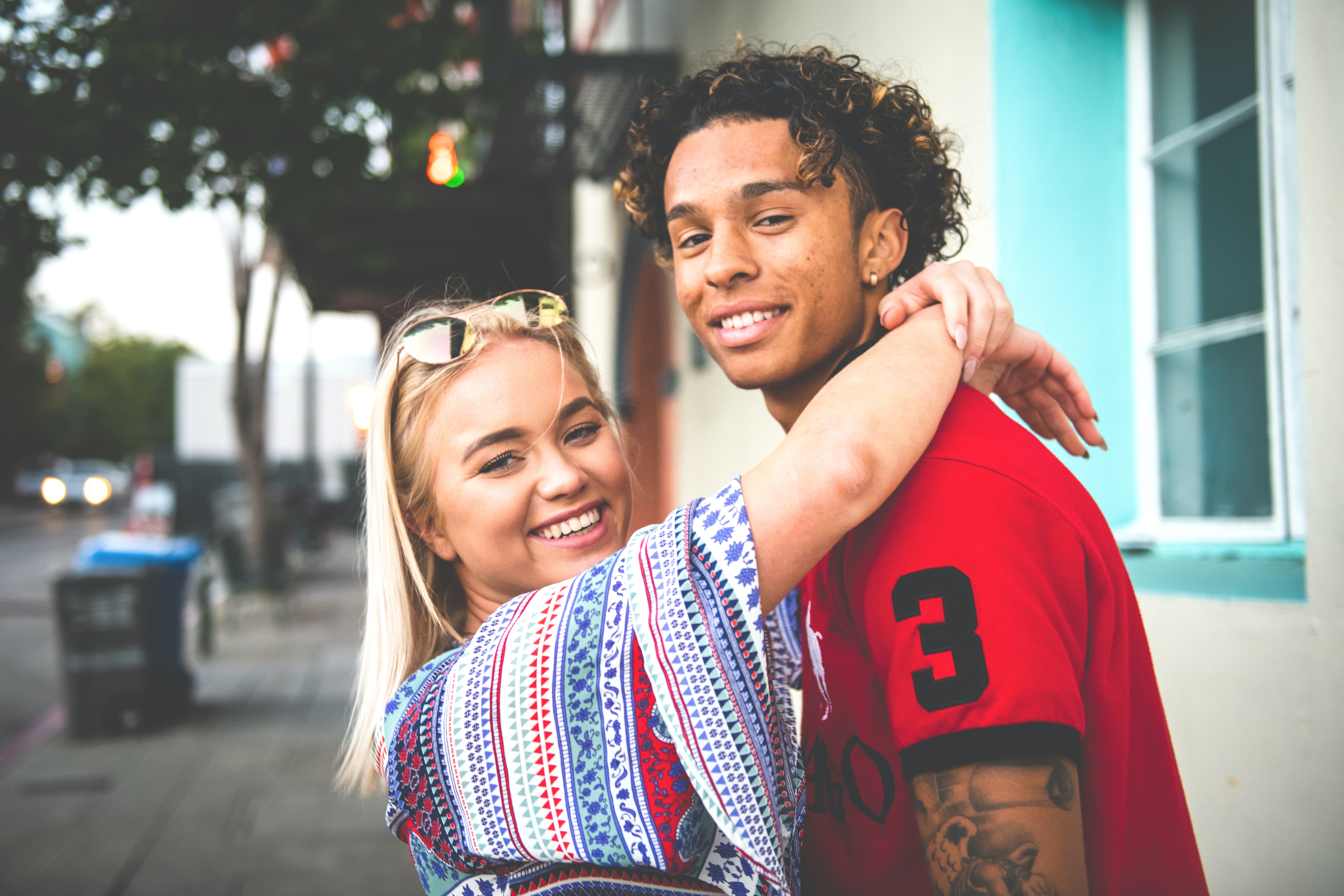 young couple looking at camera while hugging