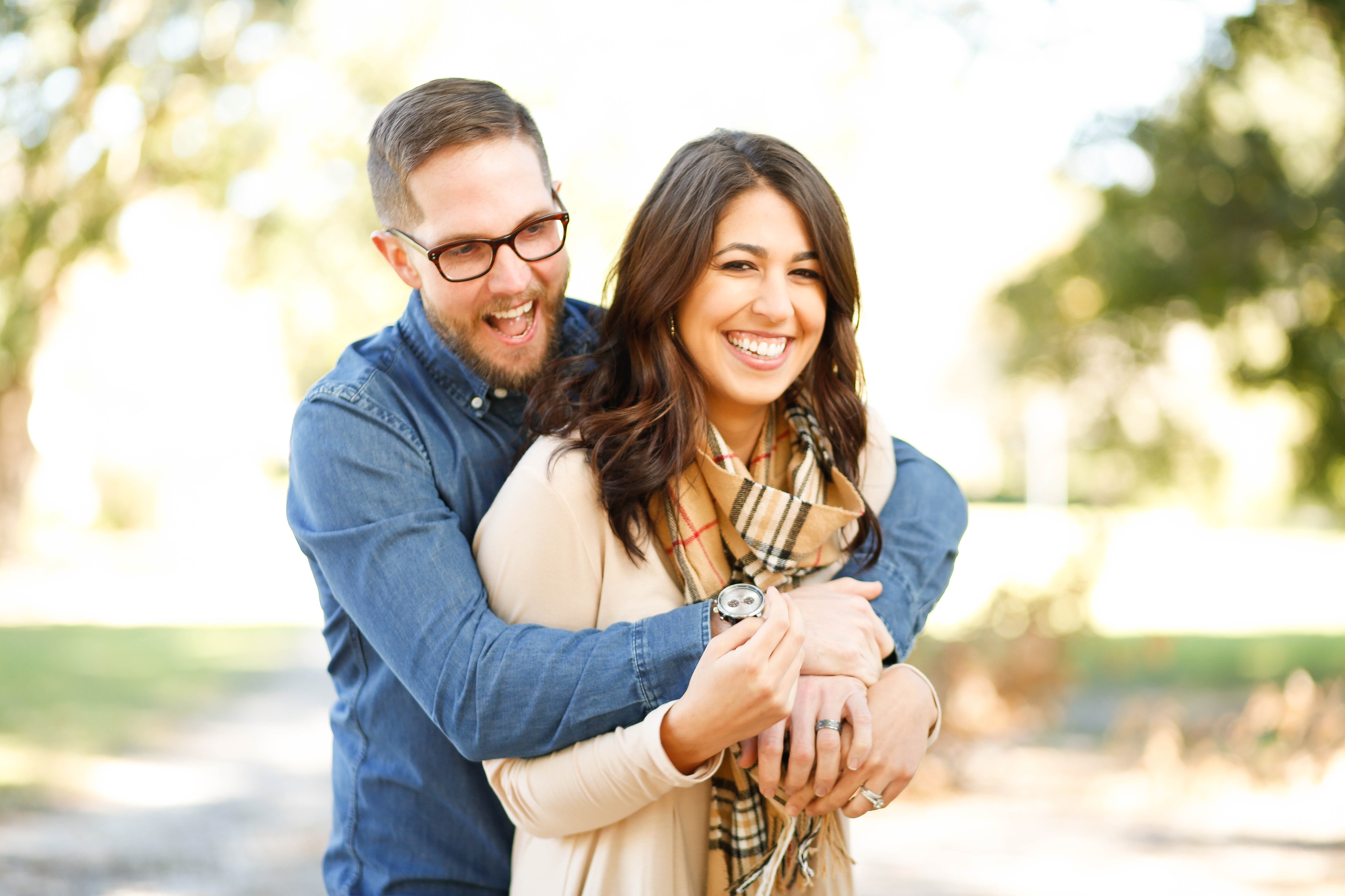 hug from behind happy young couple